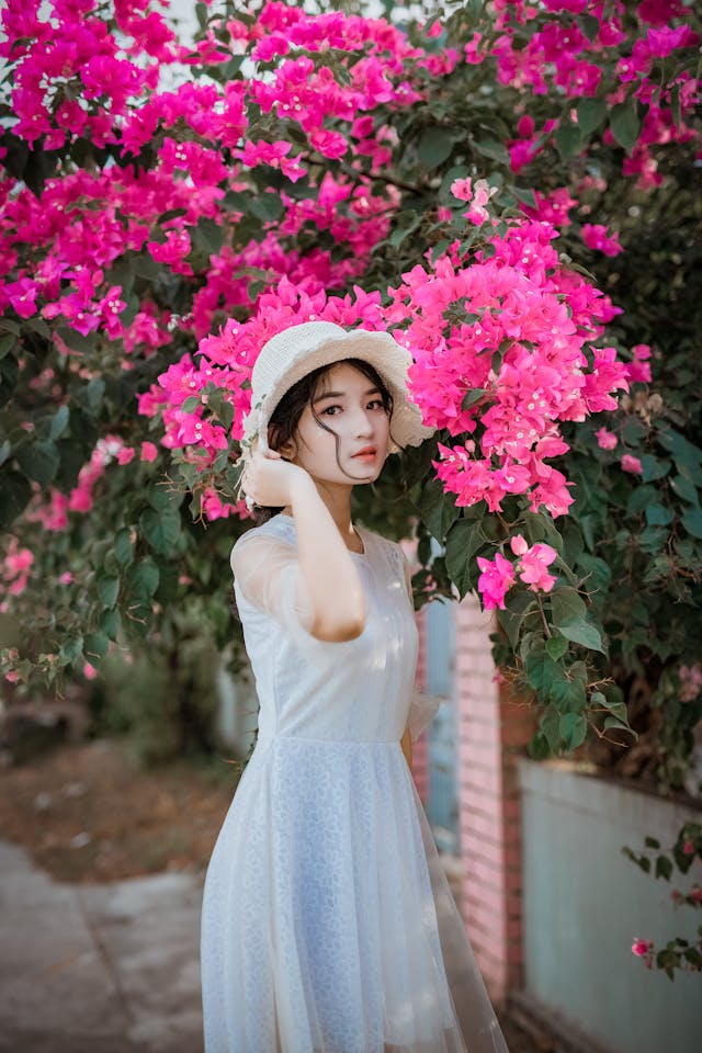 “A girl posing beside bright bougainvillea flowers in a sunlit garden.” ☀️